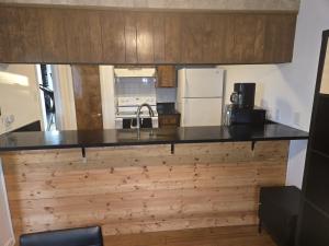 a kitchen with a counter top and a refrigerator at Sunshine village in Euless