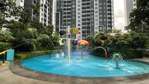 a pool with a water park in a city at Aisy Suite Splash Mania View in Bandar Gamuda Cove +7 photos