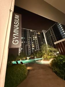 a building with a sign in front of it at night at Aisy Suite Splash Mania View in Bandar Gamuda Cove