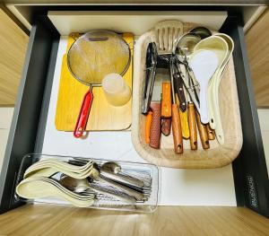 a drawer filled with utensils on a table at Aisy Suite Splash Mania View in Bandar Gamuda Cove