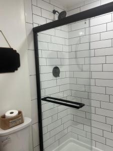 a bathroom with a shower with a glass door at Modern barn by the creek in Evergreen