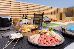 ein Tisch mit mehreren Tellern mit Essen darauf in der Unterkunft HiTOSE in Takashima