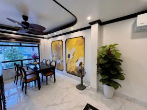 a dining room with a table and chairs and a ceiling fan at Cat Ba Cam's Villa in Cat Ba