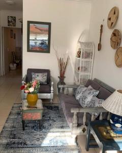 a living room with a couch and a table at Vicky holiday home in Walvis Bay