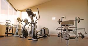 a gym with several exercise bikes in a room at Volcano View Loft, Puebla Skyline1801 in Puebla