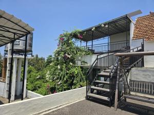 a stairway with a flowering plant on the side of a building at Keramas Selukat Guest House in Keramas