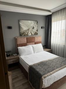 En eller flere senge i et værelse på Ankara Royal Hotel