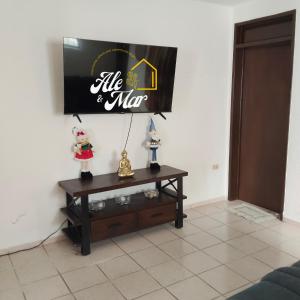a living room with a tv and a table at Casa Aleymar in Playa del Carmen