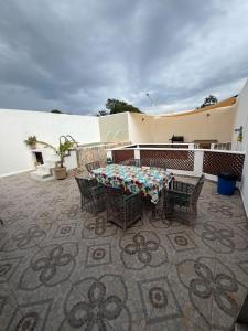 a patio with a table and chairs on a balcony at Casa Aleymar in Playa del Carmen