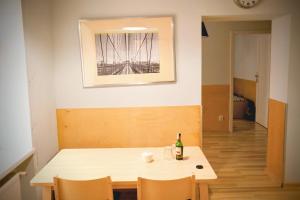 a dining room table with a bottle of wine on it at Armonia Old Town in Poznań