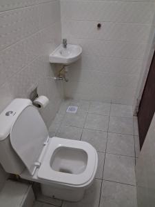 a bathroom with a toilet and a sink at Machakos Town studios in Machakos +18 photos