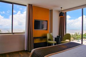 a hotel room with a bed and a view of the ocean at Dragon Sea Sam Son Hotel in Sầm Sơn