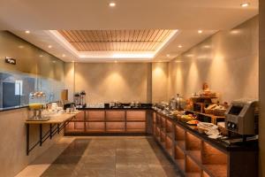 a large kitchen with a long counter in a room at Classik Fort Inn & Suites in Cochin