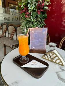 a glass of orange juice sitting on a table at Diamond Hotel Sapa in Sapa