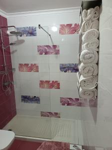 a bathroom with a shower with a bunch of towels at Antonio del Toro in Lora del Río