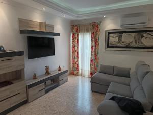 a living room with a couch and a television at Antonio del Toro in Lora del Río