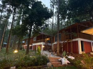 a house in the woods with stairs leading to it at The Wild Deck - Chikkamagaluru in Chikmagalūr