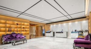 a large room with purple furniture and a lobby at Oriental Glory Hotel in Dongguan +217 photos