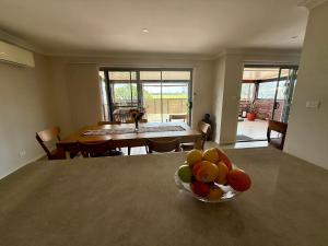 a bowl of fruit on a table in a kitchen at Coolamon in Ballina +15 photos