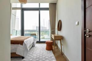 a bedroom with a bed and a floor to ceiling window at Private Room in Luxurious 3BR Apartment with BURJ KHALIFA view in Downtown near Dubai Mall in Dubai +45 photos