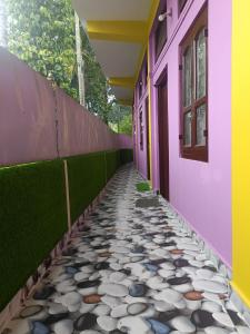 a corridor of a house with a walkway at Destiny Lodge & Homestay in Nāzirā