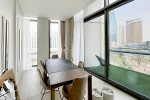 a dining room with a table and a large window at Private Room in Luxurious 3BR Apartment with BURJ KHALIFA view in Downtown near Dubai Mall in Dubai