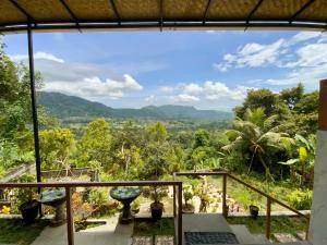 a view of the mountains from the balcony of a house at Rumah Bagus Jayanti in Sidemen