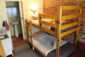two bunk beds in a room with a sink at Dunford's Loft in Himeville