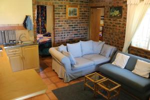 a living room with a couch and a table at Dunford's Loft in Himeville