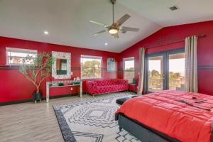 a red bedroom with a red bed and a red couch at 3-Acre Retreat, 3 Mi to Dtwn Jensen! Upscale Home in Jensen Beach