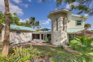 a house with a green roof at 3-Acre Retreat, 3 Mi to Dtwn Jensen! Upscale Home in Jensen Beach