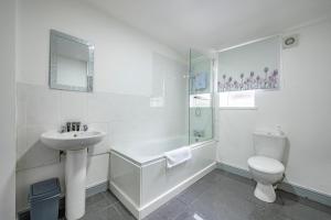 a white bathroom with a sink and a toilet at -2AA- for your most relaxed & cosy stay in Beeston