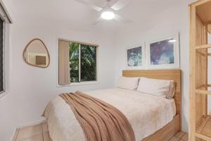 a bedroom with a bed and a ceiling fan at 1/24 Birch Street in Amity Point