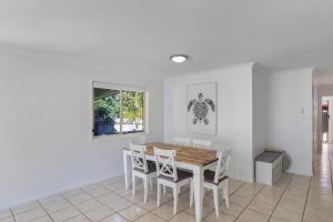 a dining room with a table and chairs at Barefoot Haven in Amity Point