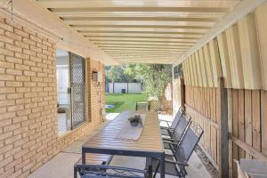 a patio with a wooden table and chairs at Barefoot Haven in Amity Point