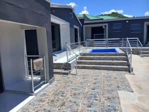 a patio with stairs and a swimming pool at Baraba's guest house in Nelspruit