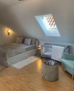 a attic bedroom with a bed and a skylight at All Homes Apartments in Bad Schallerbach