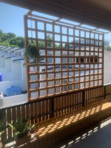a window on a balcony with a view at Nai Yang Guest House in Nai Yang Beach