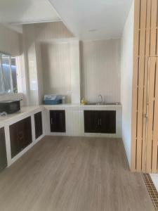 an empty kitchen with a sink and a counter at Nai Yang Guest House in Nai Yang Beach +28 photos