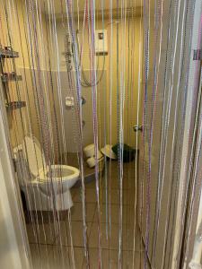a bathroom with a toilet in a cage at 2 Bedroom Condominium in Cagayan de Oro +5 photos