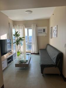 a living room with a couch and a glass table at 2 Bedroom Condominium in Cagayan de Oro