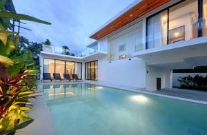 a swimming pool in the backyard of a house at Tropical Luxury Samui Villa Donava in Nathon Bay