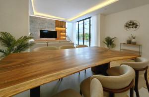 a dining room with a large wooden table and chairs at Tropical Luxury Samui Villa Donava in Nathon Bay
