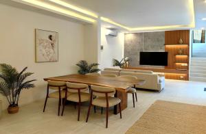 a living room with a wooden table and chairs at Tropical Luxury Samui Villa Donava in Nathon Bay