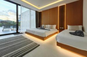 a bedroom with two beds and a large window at Tropical Luxury Samui Villa Donava in Nathon Bay +11 photos