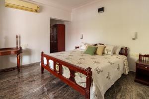 a bedroom with a bed and a piano at Orma in Cochin