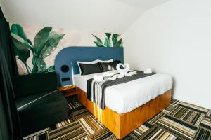 a bedroom with a bed and a chair at PARK INN, Bugojno in Bugojno +81 photos