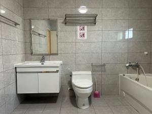 a bathroom with a toilet and a sink and a tub at Shower & Sleep in Huxi +48 photos