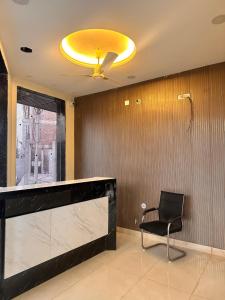 a lobby with a chair and a yellow ceiling at Hotel RK Palace Vrindavan - Near Bankey Bihari and Prem Mandir in Vrindāvan