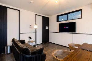 a living room with a couch and a table at AMP FLAT Marron Hontosu in Tosu